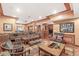 A spacious basement is decorated with warm colors and has a large patterned sofa and an ottoman at 5977 S 800 E, Zionsville, IN 46077