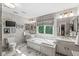 Bright primary bathroom featuring a soaking tub, dual sinks, and marble floors at 5977 S 800 E, Zionsville, IN 46077