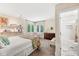 Inviting bedroom with neutral colors, reading chair, and attached bathroom at 5977 S 800 E, Zionsville, IN 46077