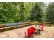 An outdoor deck has chairs, flowers, and benches, and is surrounded by mature trees at 5977 S 800 E, Zionsville, IN 46077