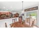 Open dining area featuring a wood table, chairs, views of the backyard, and convenient access to the kitchen at 5977 S 800 E, Zionsville, IN 46077