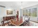 Dining room featuring a large wooden table, elegant chandelier, and scenic backyard views at 5977 S 800 E, Zionsville, IN 46077