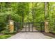 Private entrance gate with stone pillars and wrought iron design leading to the property at 5977 S 800 E, Zionsville, IN 46077