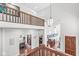 Second-story hallway with wood railing overlooking the foyer and views of the home's interior at 5977 S 800 E, Zionsville, IN 46077