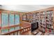 Loft office space featuring a custom bookcase and large window with privacy blinds at 5977 S 800 E, Zionsville, IN 46077