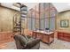 Bright home office with a spiral staircase, large windows, and wood finishes creating a warm, inviting workspace at 5977 S 800 E, Zionsville, IN 46077