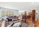 Spacious living room flowing into the kitchen with wood floors, comfortable seating, and large windows for a bright atmosphere at 5977 S 800 E, Zionsville, IN 46077