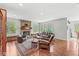 Cozy living room with a stone fireplace, wood floors, comfortable seating, and large windows for natural light at 5977 S 800 E, Zionsville, IN 46077