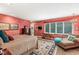 Spacious primary bedroom featuring textured walls, chaise lounge, decorative rug and large window at 5977 S 800 E, Zionsville, IN 46077