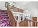 Spacious staircase with wood railing and floral patterned carpet leading to second floor at 5977 S 800 E, Zionsville, IN 46077