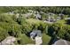 A high aerial view displays a house nestled within a neighborhood with mature tree coverage at 6208 W Foster Ridge Ln, Pendleton, IN 46064