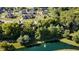 A beautiful aerial view of a neighborhood featuring lush trees and a pond with a fountain on a sunny day at 6208 W Foster Ridge Ln, Pendleton, IN 46064