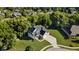 Aerial view of a beautiful two-story home featuring a well-manicured lawn and mature trees at 6208 W Foster Ridge Ln, Pendleton, IN 46064