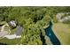 Aerial view of a beautiful home with a pond and fountain, surrounded by lush greenery and mature trees at 6208 W Foster Ridge Ln, Pendleton, IN 46064