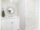 Bathroom features a stylish round mirror and a modern walk-in shower with large marble tiles at 6208 W Foster Ridge Ln, Pendleton, IN 46064