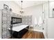 Luxurious bathroom with standalone tub, decorative tile accent wall, elegant chandelier, and glass enclosed shower at 6208 W Foster Ridge Ln, Pendleton, IN 46064