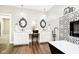 Elegant bathroom featuring double sinks, decorative mirrors, quartz countertops, a soaking tub and wood flooring at 6208 W Foster Ridge Ln, Pendleton, IN 46064