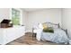 Cozy bedroom with a dresser with a vintage record player, decorative pillows, and a window view at 6208 W Foster Ridge Ln, Pendleton, IN 46064