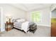 Bright bedroom features a tray ceiling, large window, neutral carpet, and charming wrought iron bed frame at 6208 W Foster Ridge Ln, Pendleton, IN 46064