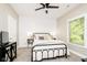 Cozy bedroom featuring a comfortable bed with a wood accent wall and a view to the outside at 6208 W Foster Ridge Ln, Pendleton, IN 46064