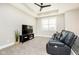 Cozy bonus room with a ceiling fan, plush seating, a large window, and an entertainment center at 6208 W Foster Ridge Ln, Pendleton, IN 46064