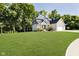 Charming two-story home with a large lawn and mature trees surrounding the property at 6208 W Foster Ridge Ln, Pendleton, IN 46064