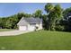 Side view of a beautiful home with a large yard and an attached two-car garage at 6208 W Foster Ridge Ln, Pendleton, IN 46064