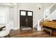 Inviting foyer with dark wood floors, a staircase with decorative iron railing, and a piano at 6208 W Foster Ridge Ln, Pendleton, IN 46064