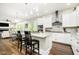 Modern kitchen with white cabinets, granite counters, breakfast bar and open to the living area, perfect for entertaining at 6208 W Foster Ridge Ln, Pendleton, IN 46064