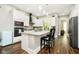 Modern kitchen boasts white cabinets, granite countertops, stainless steel appliances, and a stylish breakfast bar at 6208 W Foster Ridge Ln, Pendleton, IN 46064