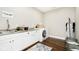 Functional laundry room with a utility sink, ample counter space, and modern appliances at 6208 W Foster Ridge Ln, Pendleton, IN 46064