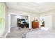 Spacious main bedroom with an open doorway to an office and a modern sliding barn door to the bathroom at 6208 W Foster Ridge Ln, Pendleton, IN 46064