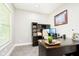 Home office featuring a large, dark wood desk with drawers and shelving, carpet, and natural light at 6208 W Foster Ridge Ln, Pendleton, IN 46064