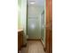 Bright half bathroom features a stand up shower with glass door and wood trim at 6725 Bridgefield Way # 1, Indianapolis, IN 46254