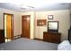 Well lit bedroom features a ceiling fan, wood door, and furniture at 6725 Bridgefield Way # 1, Indianapolis, IN 46254