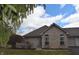 Charming brick home featuring a well-maintained lawn and an attached garage at 6725 Bridgefield Way # 1, Indianapolis, IN 46254