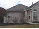 Home featuring brick detail, trimmed bushes, and manicured landscaping at 6725 Bridgefield Way # 1, Indianapolis, IN 46254