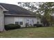 Exterior with well-maintained yard featuring shrubs and modern utility meters at 6725 Bridgefield Way # 1, Indianapolis, IN 46254