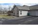 Charming home with a brick accent, gray siding, well-kept lawn and paved drive leading to attached garage at 6725 Bridgefield Way # 1, Indianapolis, IN 46254
