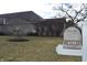 View of a house with a U.S. Mail mailbox, tree, and landscaping at 6725 Bridgefield Way # 1, Indianapolis, IN 46254