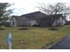 Exterior shot of a home with well-maintained lawns, shrubbery, and a paved driveway at 6725 Bridgefield Way # 1, Indianapolis, IN 46254