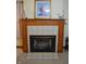Close-up of a traditional fireplace with decorative tiling and a rustic wooden mantel, a cozy focal point at 6725 Bridgefield Way # 1, Indianapolis, IN 46254