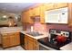 Well-lit kitchen boasts stainless steel appliances and ample cabinet space with view to living area at 6725 Bridgefield Way # 1, Indianapolis, IN 46254