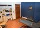 Office space with blue accent wall, wood door, and work space at 6725 Bridgefield Way # 1, Indianapolis, IN 46254