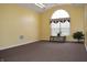 Neutral room featuring a vaulted ceiling, carpet, and a view of the backyard at 6725 Bridgefield Way # 1, Indianapolis, IN 46254