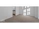 Sunlit bedroom features neutral carpet, light walls, and a view to another room at 7070 Nine Penny Dr, Brownsburg, IN 46112