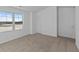 Bright bedroom with neutral carpet, a large window, and natural light at 7070 Nine Penny Dr, Brownsburg, IN 46112