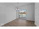 Dining room features modern chandelier, luxury vinyl plank flooring, and sliding glass doors to the balcony at 7070 Nine Penny Dr, Brownsburg, IN 46112
