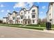 A stylish neighborhood of modern townhomes featuring well-kept lawns and striking architectural details at 7070 Nine Penny Dr, Brownsburg, IN 46112