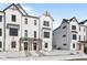 Charming two-story townhomes featuring a modern farmhouse design, black trim and snowy ground at 7070 Nine Penny Dr, Brownsburg, IN 46112